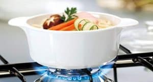 Corningware 3-Piece Multisize Ceramic Baking Dish on a burner image