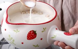 ceramic milk pan with strawberries on it